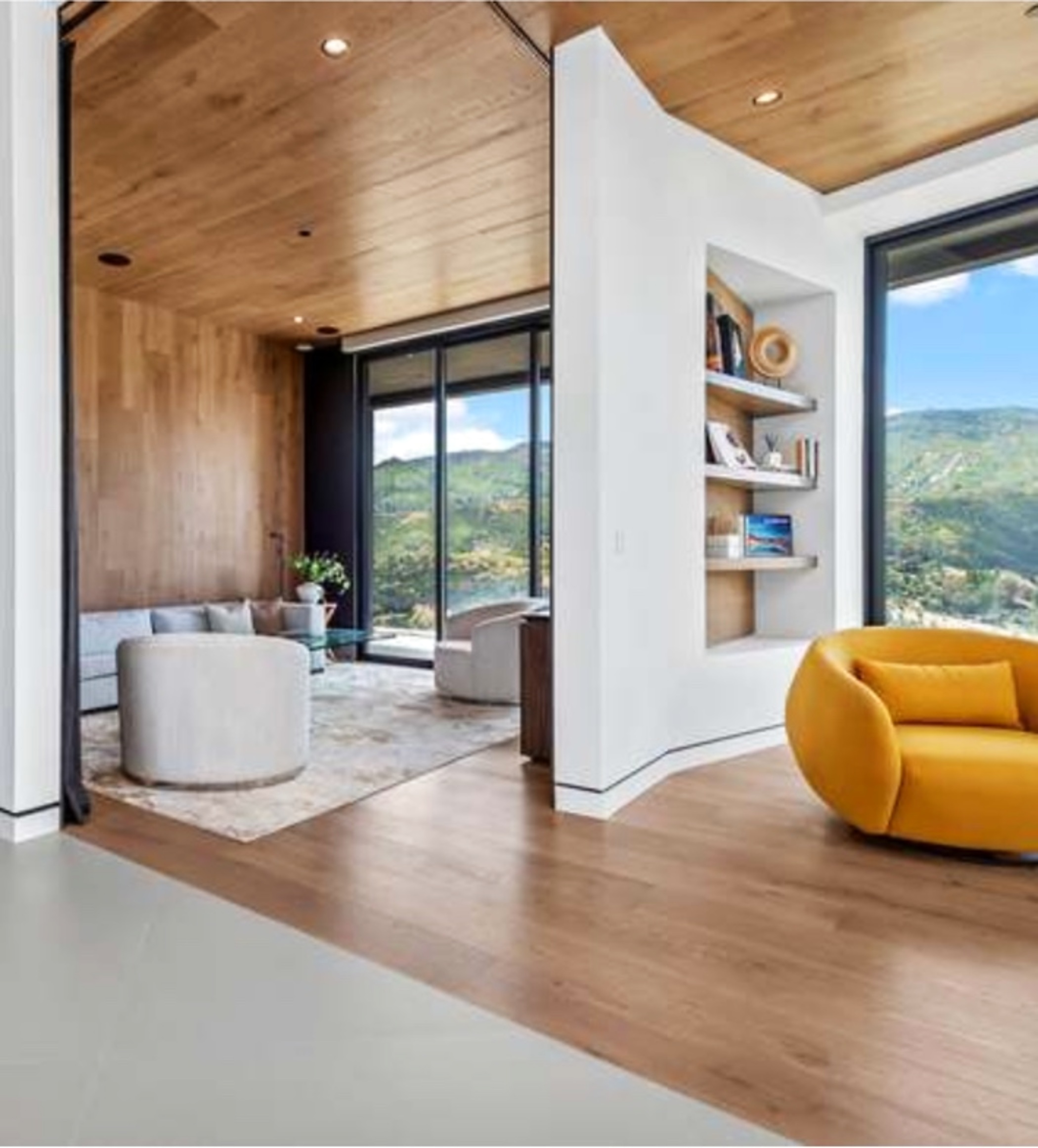 Modern interior with wood ceiling and mountain views